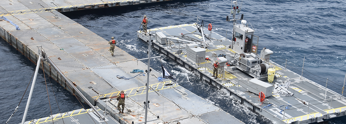 U.S. military personnel work on construction of the floating Joint Logistics Over the Sea (JLOTS) pier in the Mediterranean Sea off the coast of the Gaza Strip, April 26, 2024